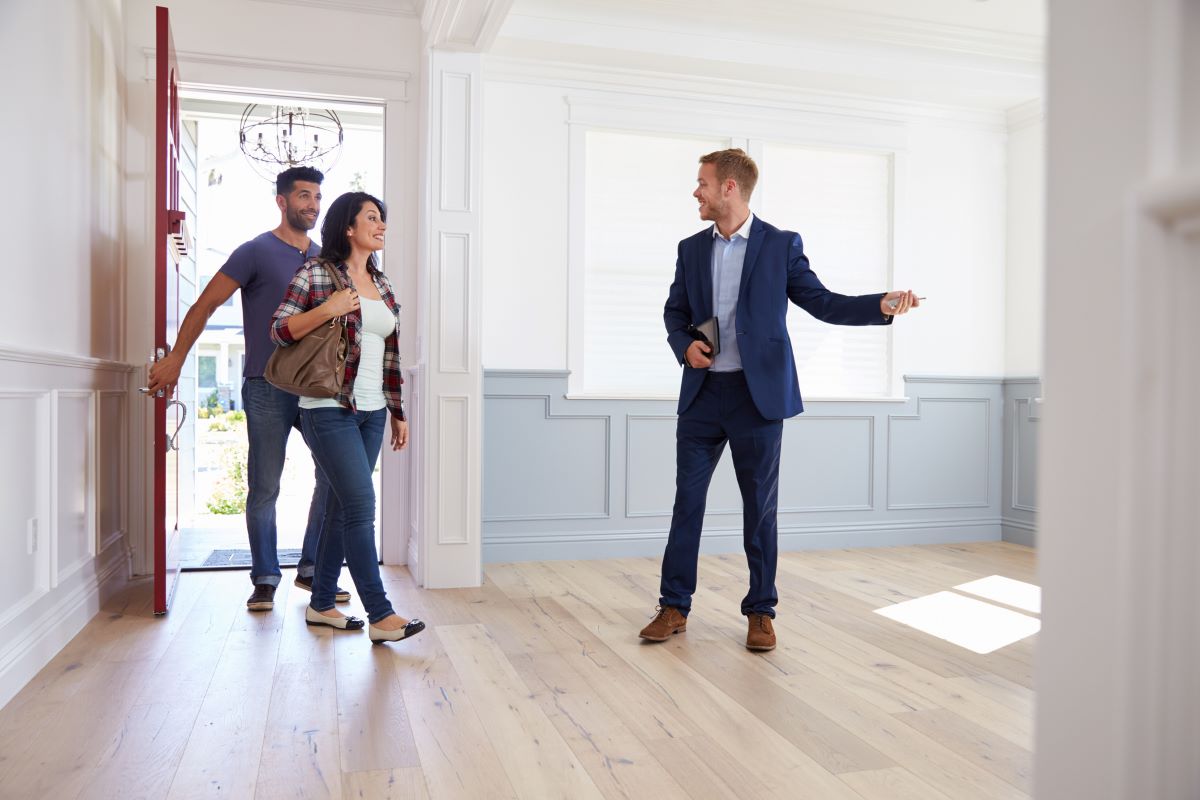 couple viewing new home with estate agent