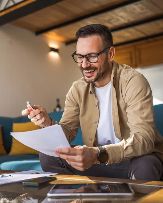 Man Mature Caucasian Male Work At Home Hold Contract Document Smile